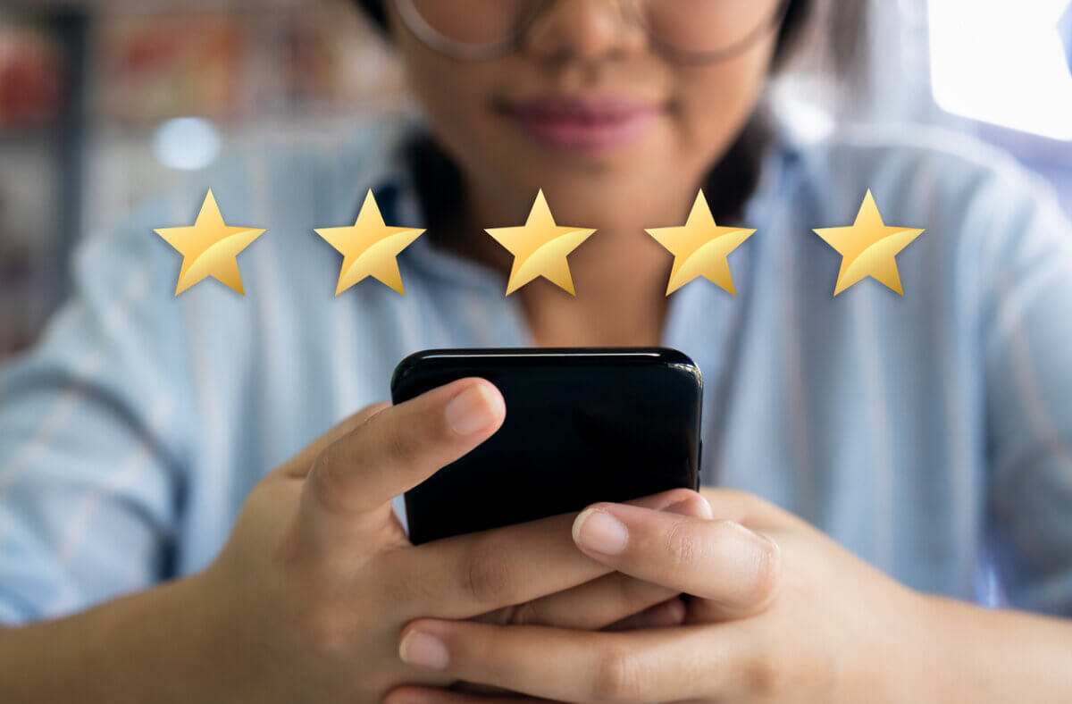 Woman using cell phone with 5 gold star customer satisfaction graphic - AArete